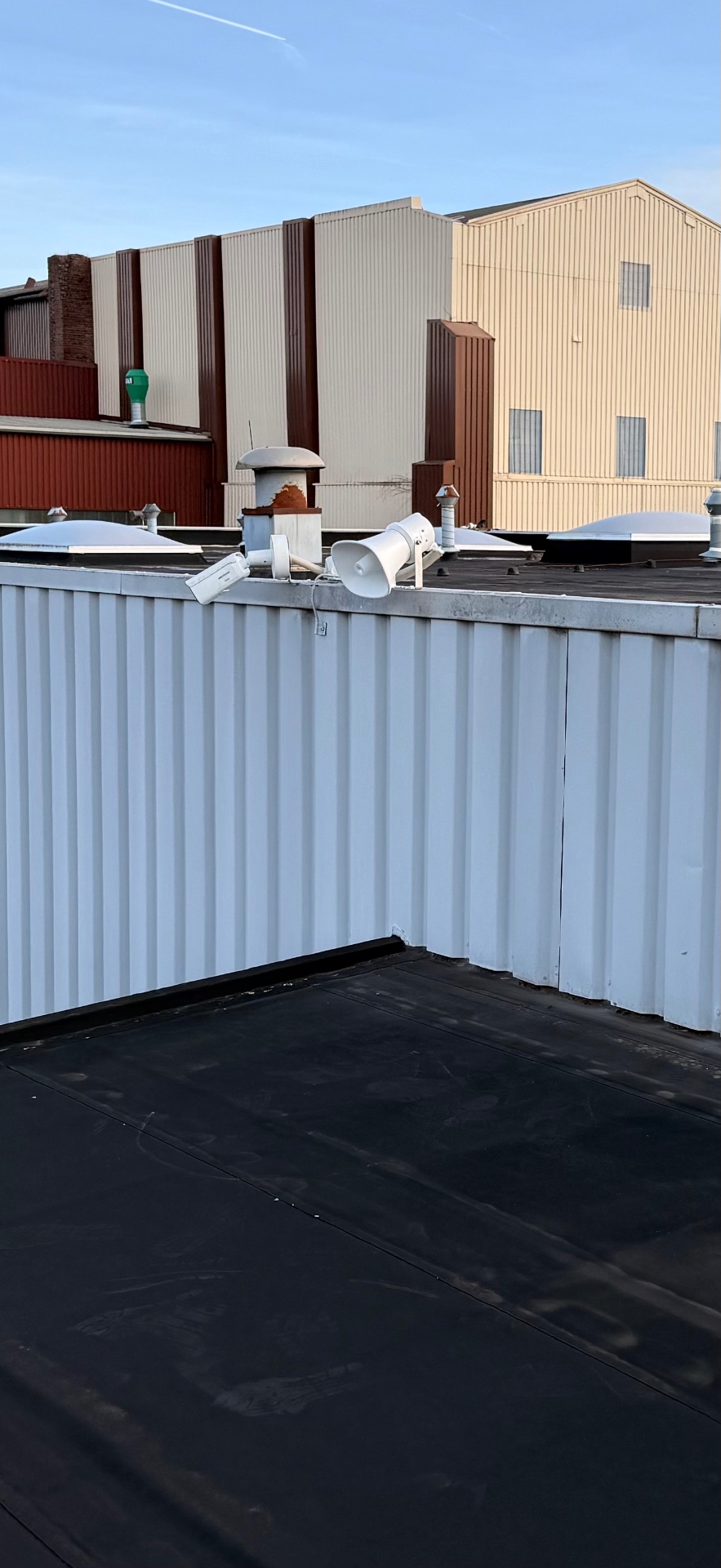 Bullet-Kamera und Lautsprecher auf einem Flachdach mit sauberer CAT7-Outdoor-Verkabelung